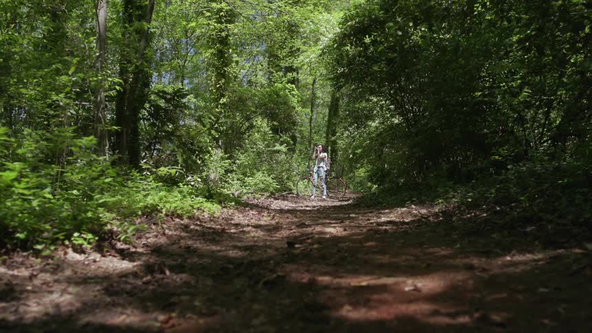 A woman takes photos in the woods