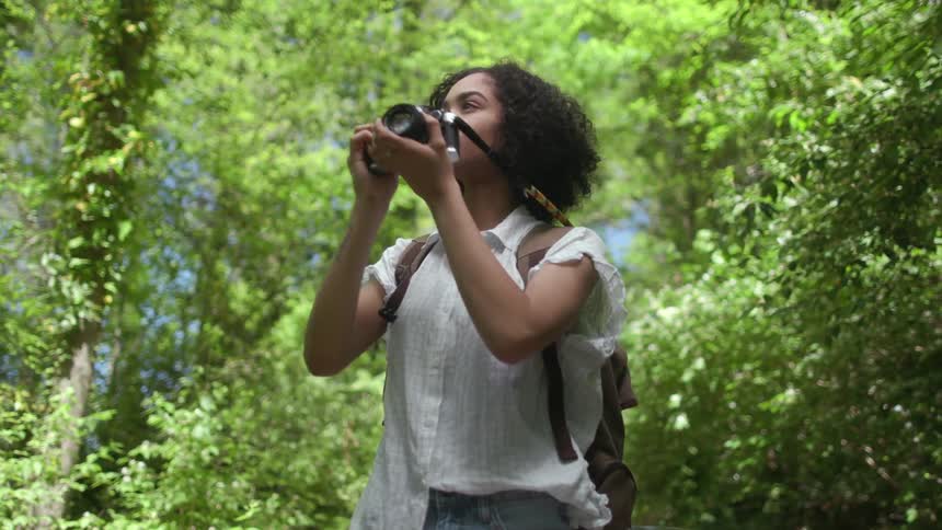A woman is photographing the forest