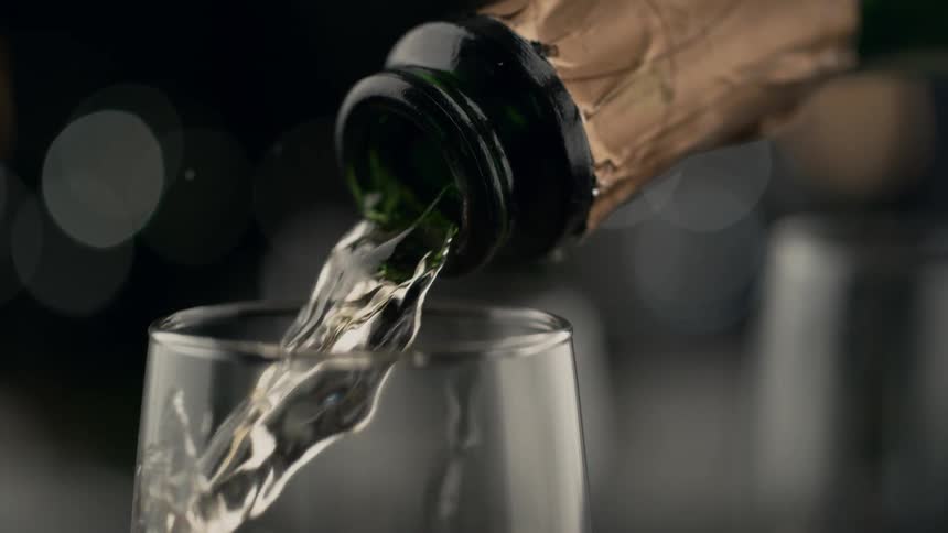 White wine is poured into a glass