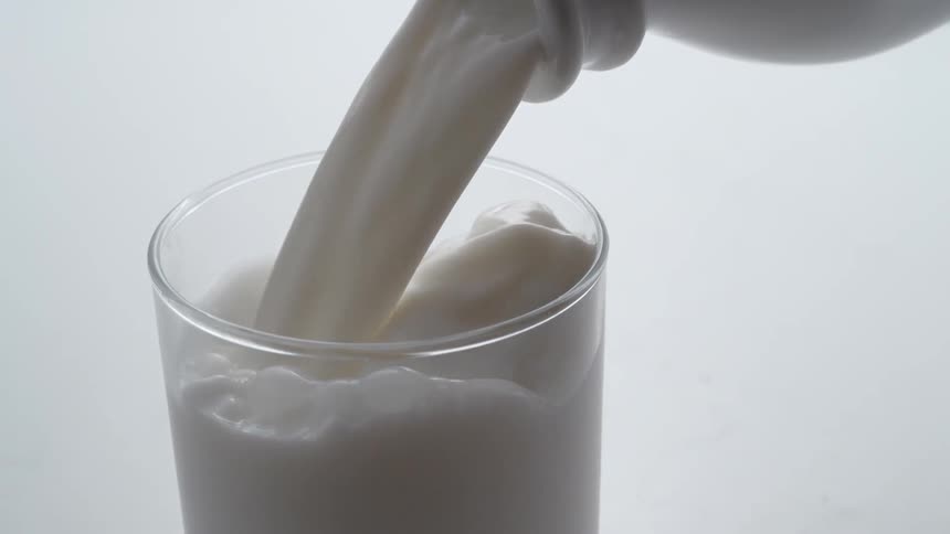 Milk is poured into a glass