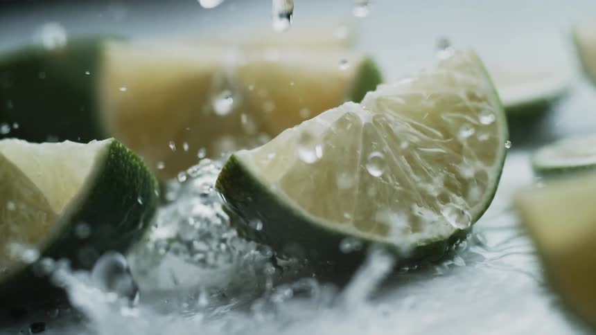 Water splashes on lime wedges