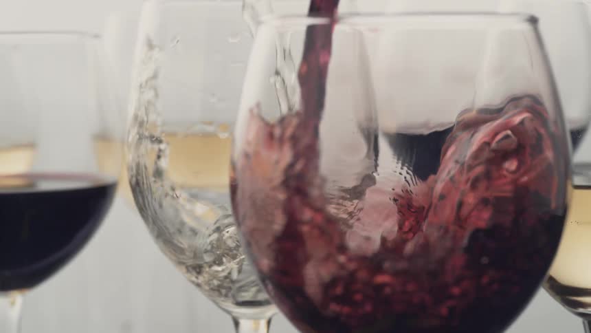 Red wine is poured into a glass