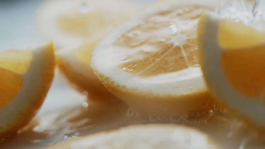 Water splashing onto fresh lemon slices