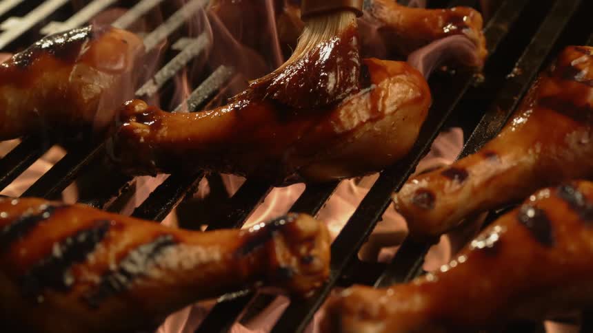 Chicken is cooked on the flaming grill