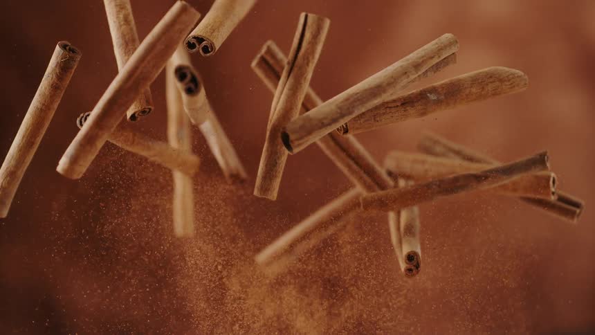 Cinnamon sticks are flying into the air