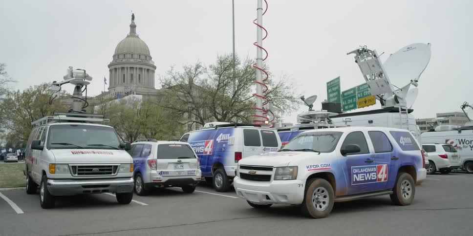 News trucks are parked together