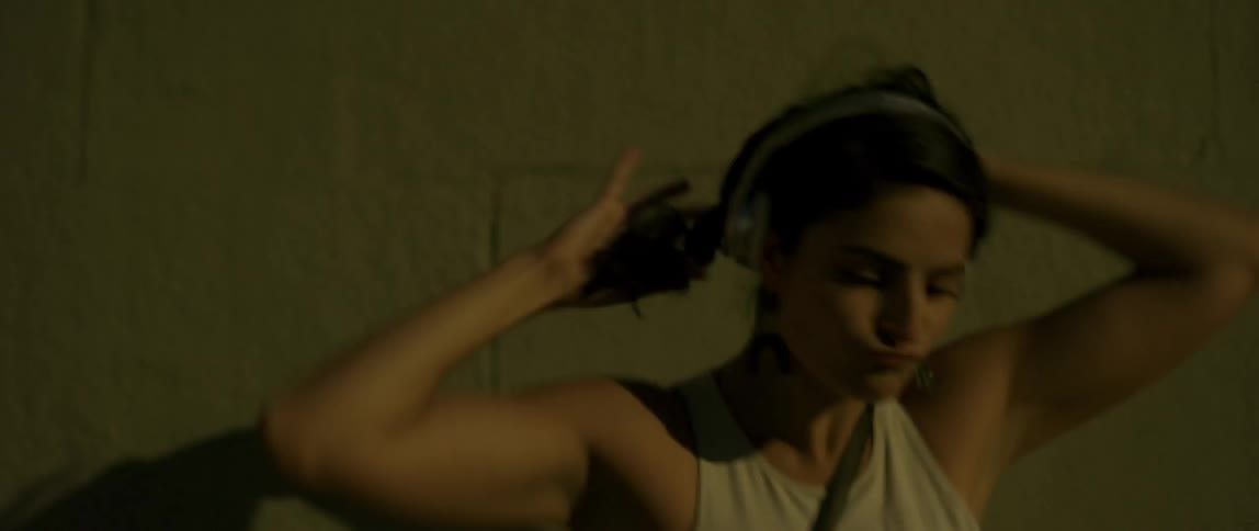 Woman dances and puts her hair up