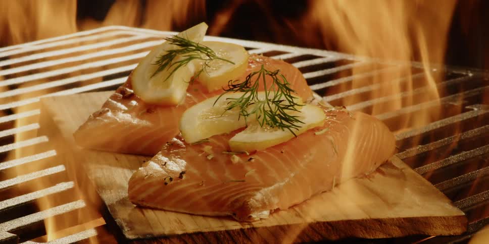 Fish is grilled on a wood plank