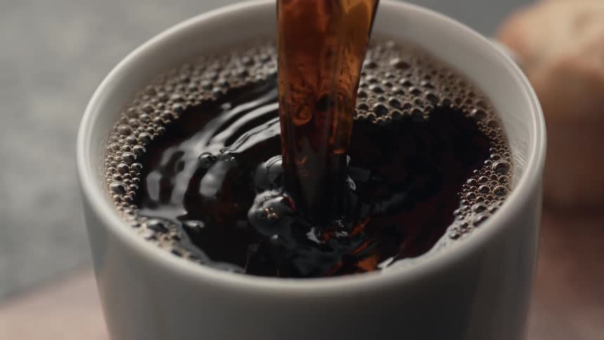 Coffee is poured into a mug