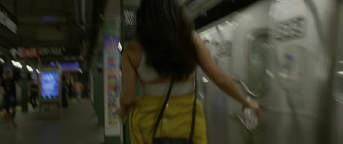 A woman dances and runs as the train passes