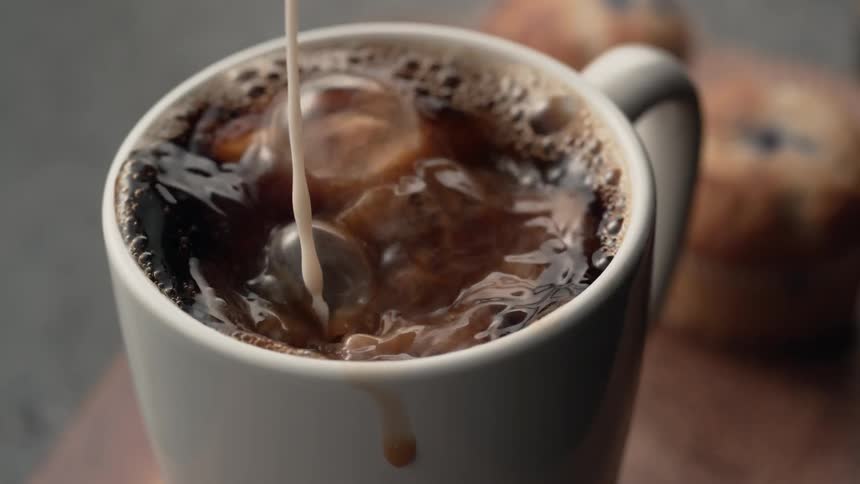 Cream splashing into coffee