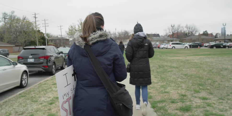 A protester carries a sign outside
