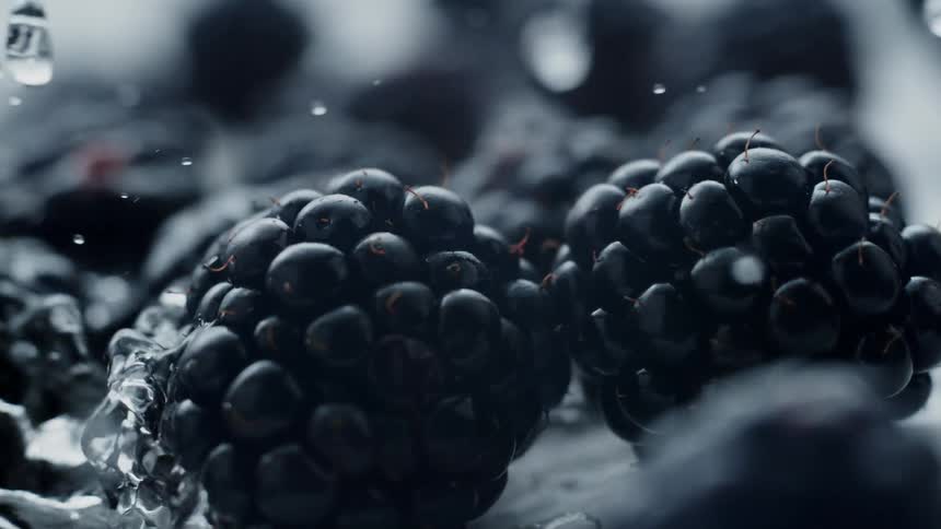 Water pours over fresh blackberries