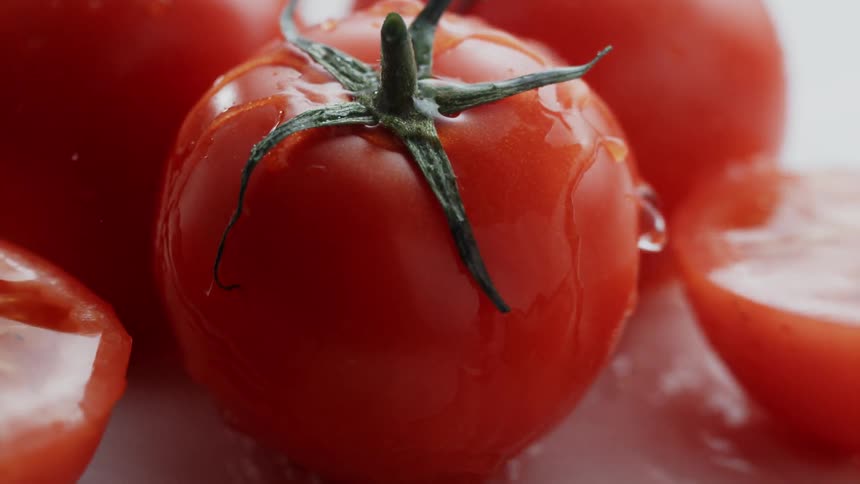 Water splashing over fresh tomato