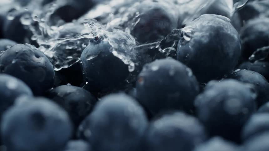 Water splashing onto fresh blueberries