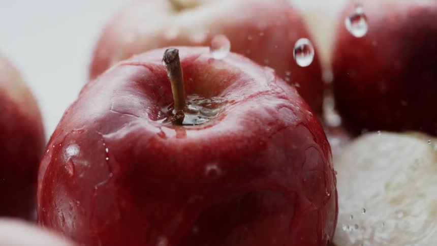 Water splashes on red apples