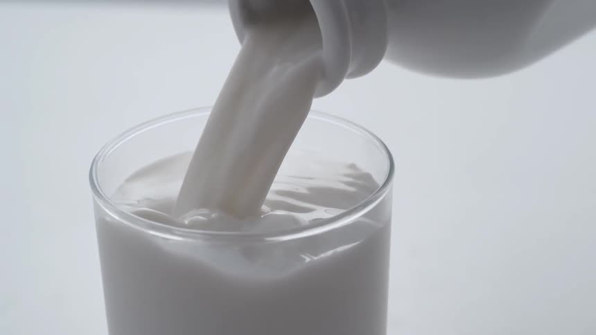 Milk is poured into a glass
