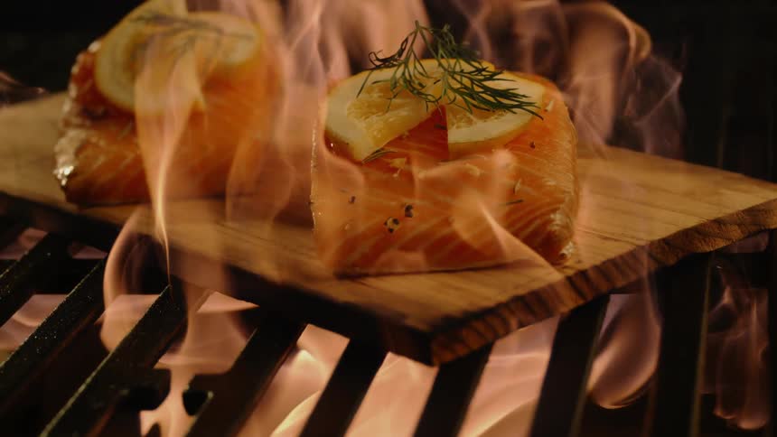 Cedar plank salmon on firey barbeque grill