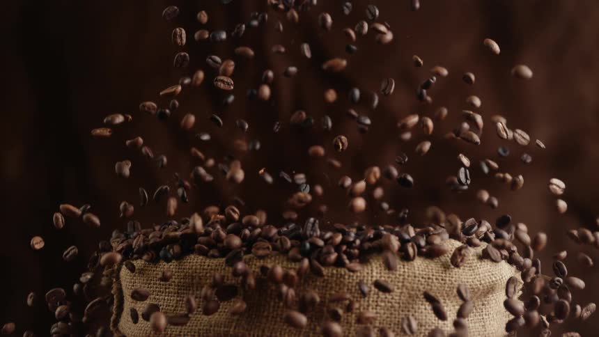 Coffee beans explode from burlap bag