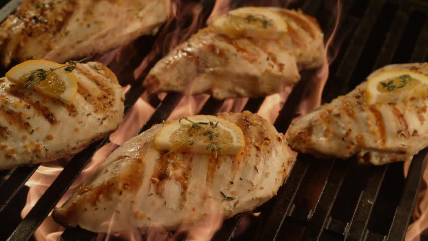Chicken with lemon and rosemary on grill