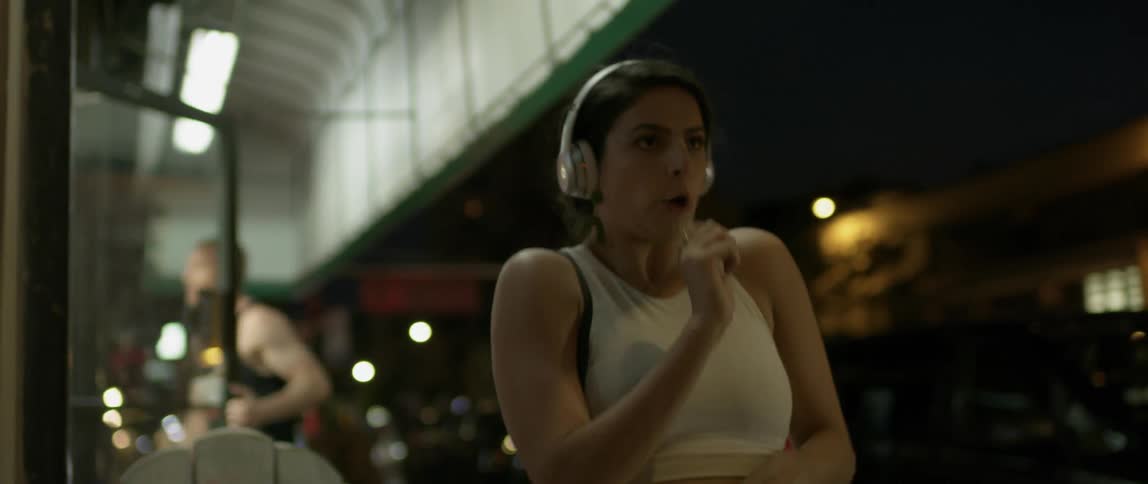 Woman dances in the city at night