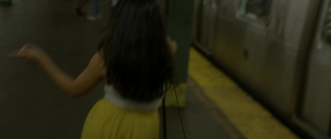 A woman is dancing inside a subway station