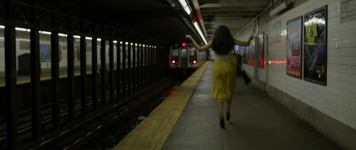 Woman dances as subway passes