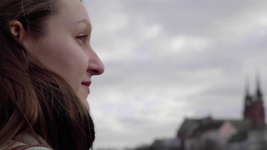 A woman looks out towards the town