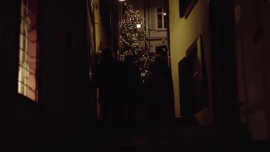 People walk up and down stairs in the alleyway