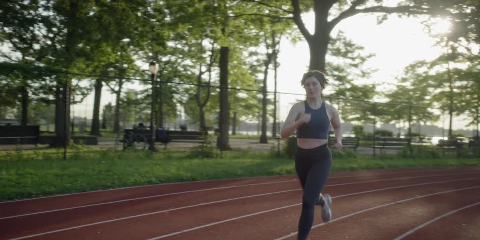Woman jogging at a track in the afternoon