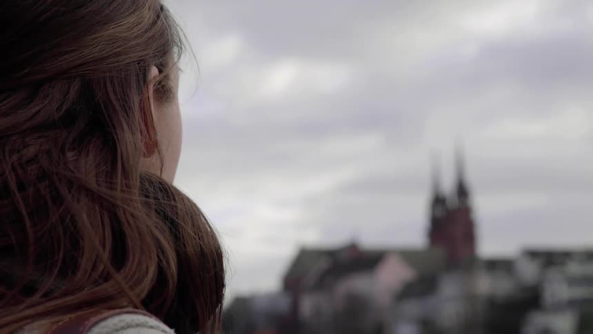 A woman looks out towards the city