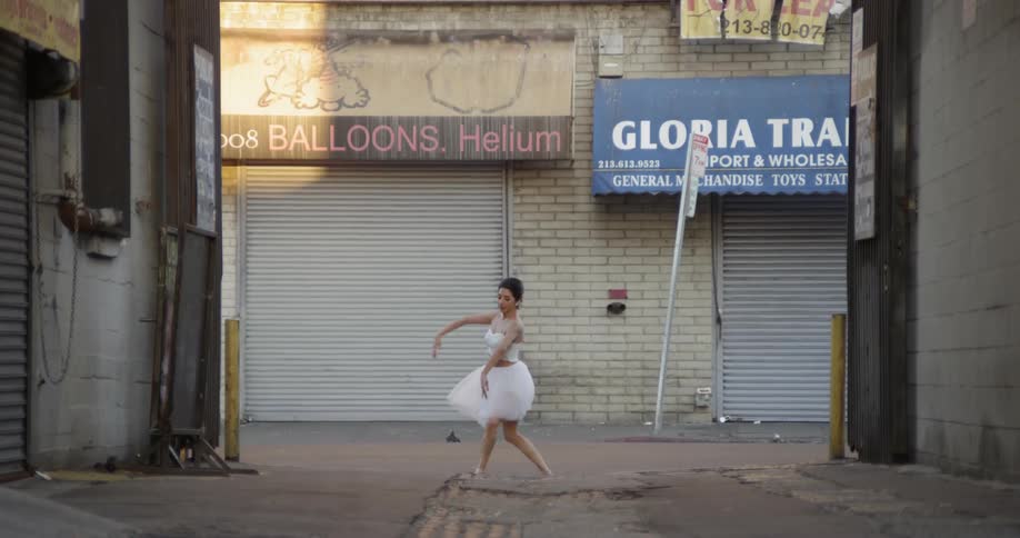 A ballet dancer dances in the alley