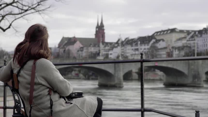 Woman Sitting by a River