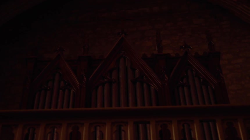 The pipes of a church organ in the balcony