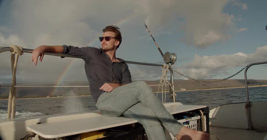 Man sitting on a boat staring out at the water