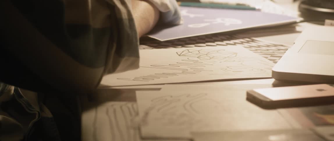 A man is drawing on some paper