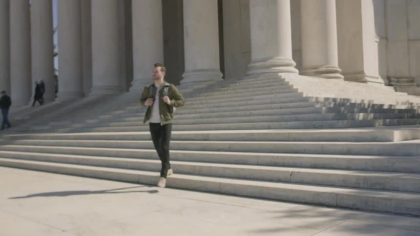 A man walks down the steps of the monument