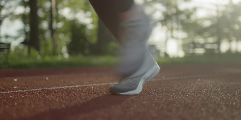 A woman jogs on the clay track