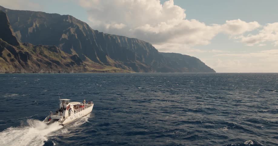 A boat sails along a coastline