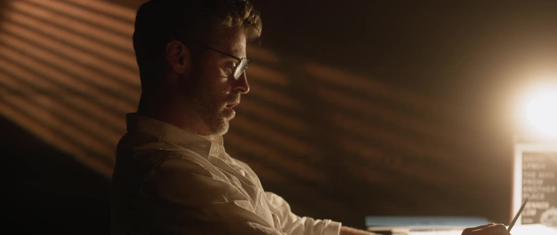 A man is startled awake on a desk