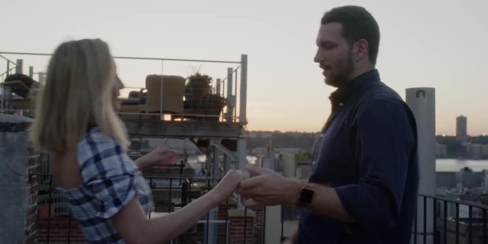 A man and woman dance on the balcony
