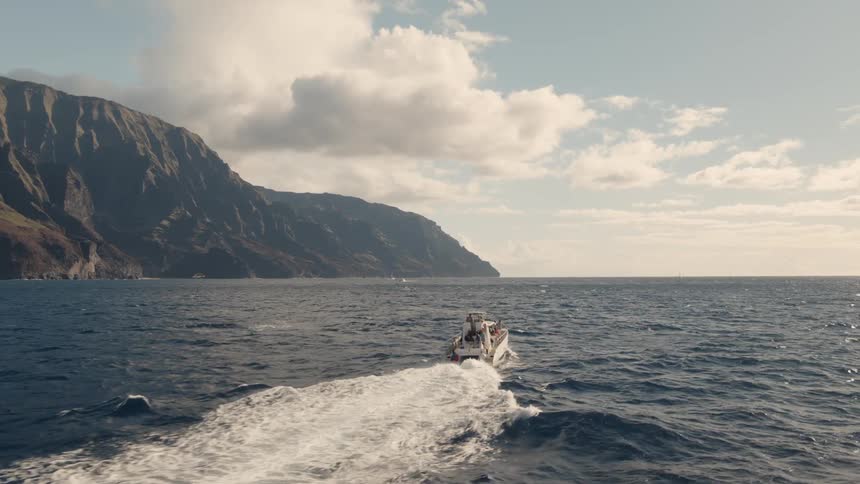 A boat speeds off on the water