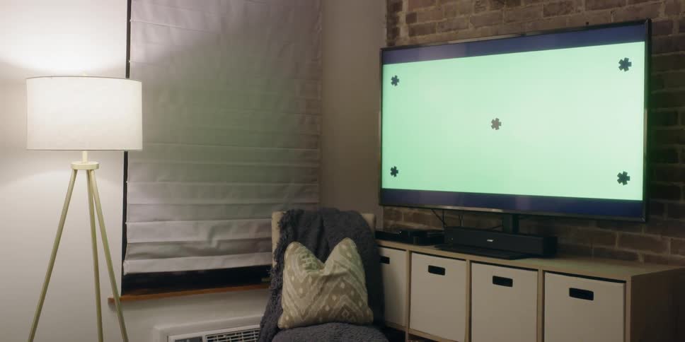 A large screen tv sits on the stand in the living room