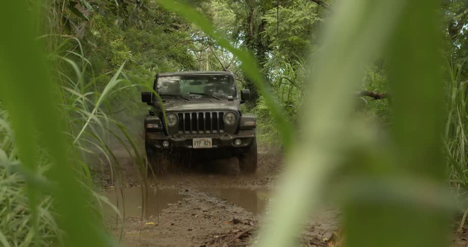 Jeep traveling across muddy path