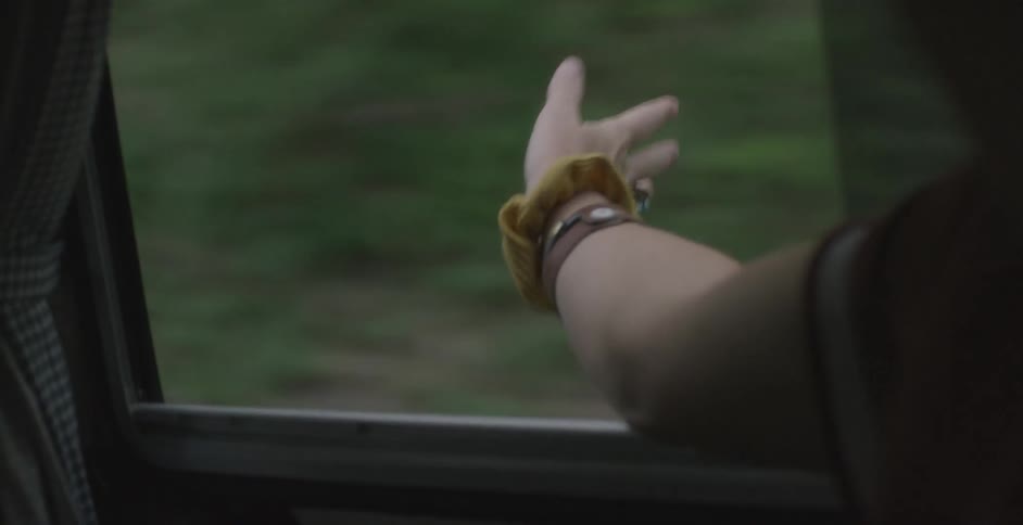 A person with their hand out of a window