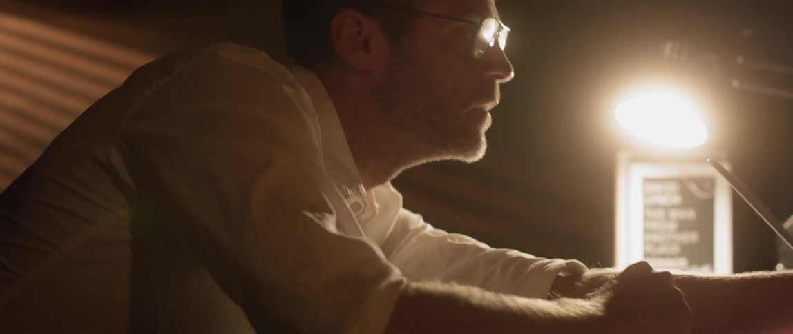 A man is startled awake on a desk