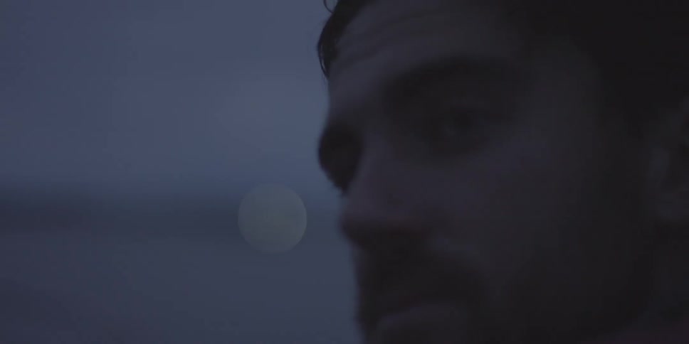 Man looks at a boat in the distance