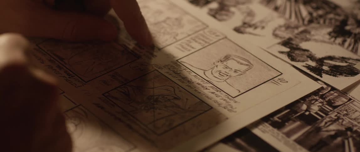 A comic book artist works on a page