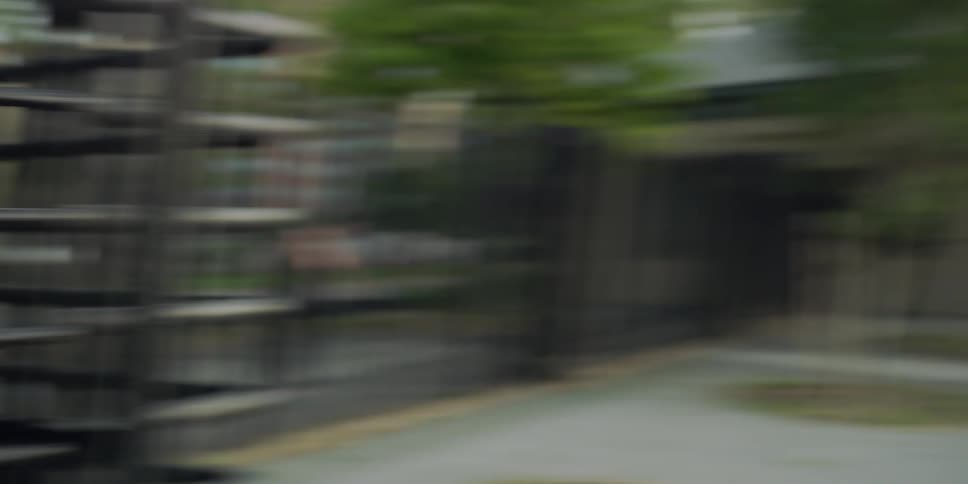 Woman with backpack enters turnstile to outdoor track