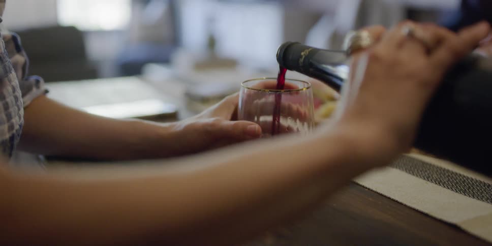 Wine is poured into a wine glass